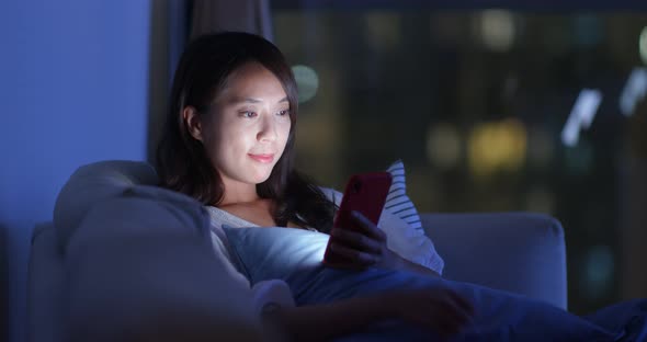 Woman Look at Smart Phone at Home in The Evening