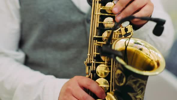 Close Up of Male's Hands Playing the Saxophone
