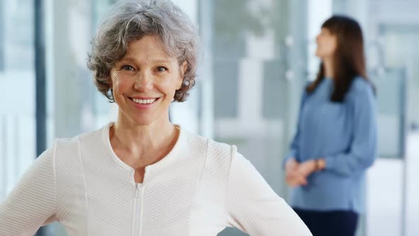 Smiling businesswoman standing in office