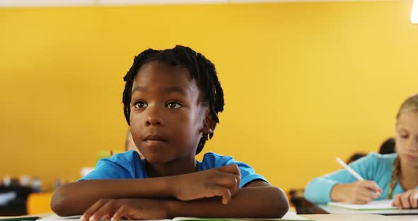 Boy raising hand in classroom