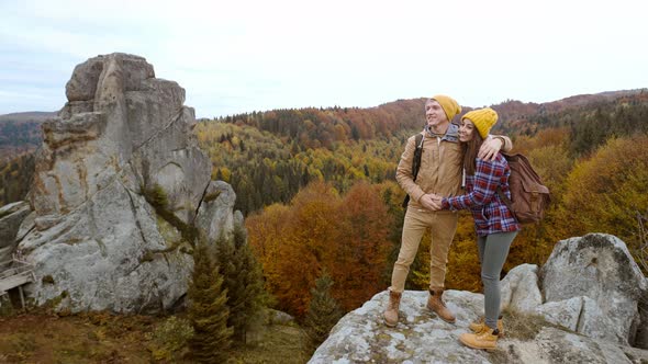 Couple Smiling Tourists Stands on Autumn Landscape Background with Cliffs in National Park Tustan