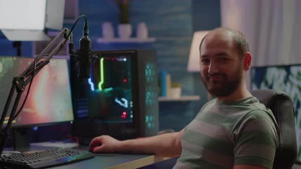 Streamer Man Looking at Camera Smiling While Streaming Videogames