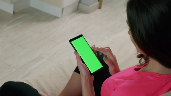 Back View Woman Holding Chroma Key Green Screen Smartphone Watching Content Touching Swiping