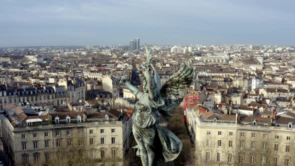 Angel of liberty Girondins monument Bordeaux, France with city panoramic, Aerial dolly out reveal sh