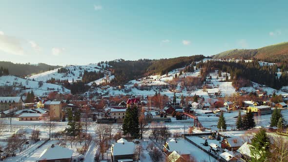 The Train Departs From the Railway Station in a Town in the Mountains in Winter