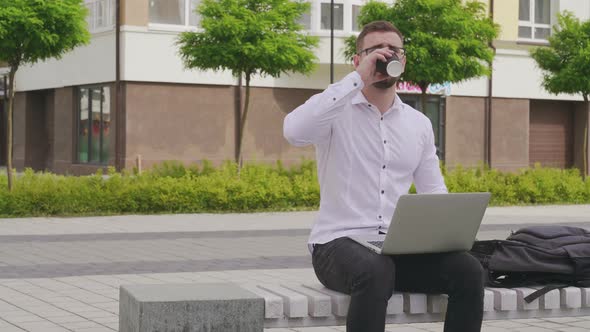 Young Freelancer Working on Laptop Outdoors