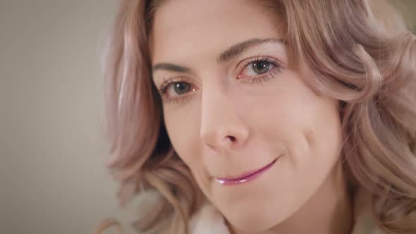 Close-up of Charming Caucasian Woman Applying Lipstick, Sending Air Kiss To Camera and Winking