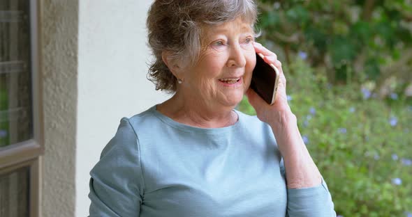 Senior Woman Talking on Mobile Phone at Home 4k
