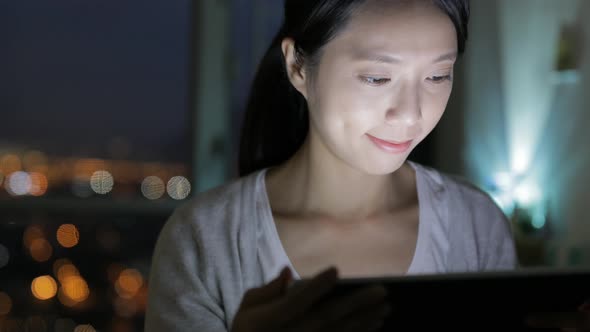 Woman using tablet computer at home 