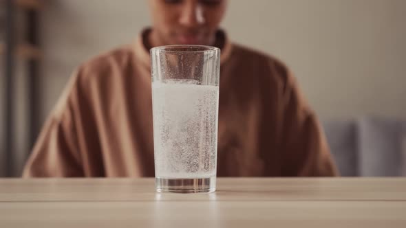 Close Up Sparkling Water Glass with Dissolving Effervescent Aspirin Pill