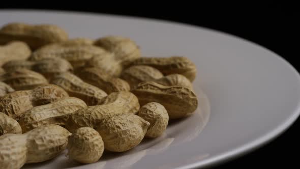 Cinematic, rotating shot of peanuts on a white surface - PEANUTS 013