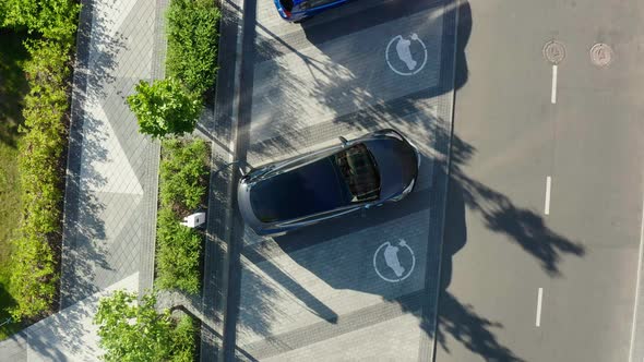 Aerial view of a white electric vehicle driving. 