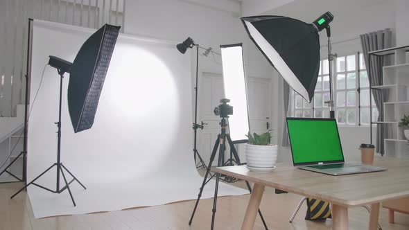 Photo Studio With Professional Equipment And Green Screen Laptop Computer Display