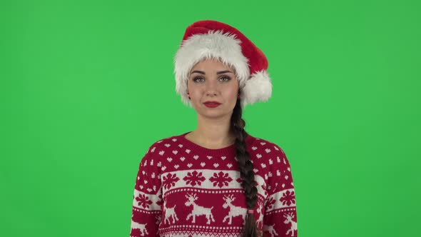 Portrait of Sweety Girl in Santa Claus Hat Is Making Sign Ok. Green Screen