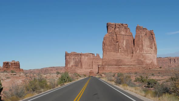 Driving On Road Through Amazing Arches National Park In Utah On Sunny Hot Day