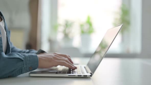 Close Up of Male Hand Closing Laptop