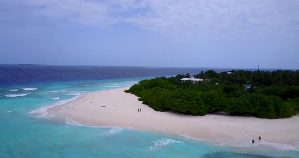 Tropical above travel shot of a white paradise beach and aqua blue ocean background in 4K