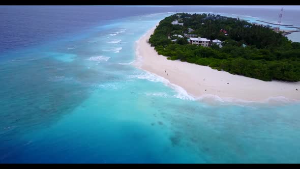 Aerial drone view panorama of beautiful tourist beach adventure by blue green lagoon and white sandy