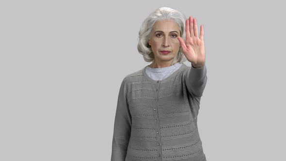 Retired Old Lady Showing Stop Gesture with Her Hand