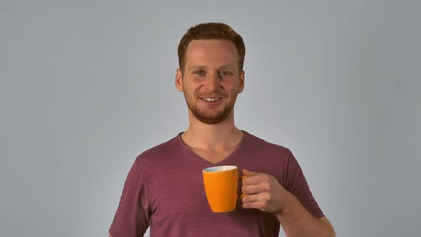 Ginger Student Holds Mug with Happy Smile