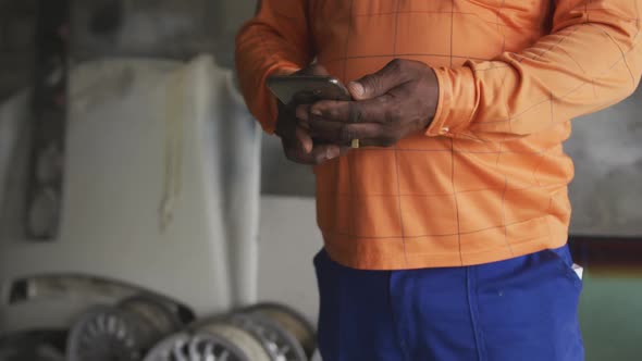 African man using phone at work