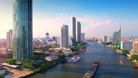 4K : Drones fly over the Chao Phraya River, buildings and business districts in Bangkok