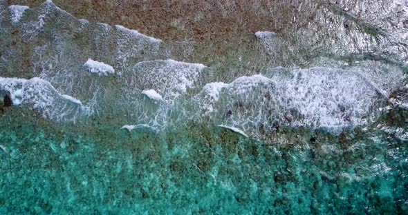 Tropical birds eye abstract shot of a white paradise beach and turquoise sea background in hi res 4K