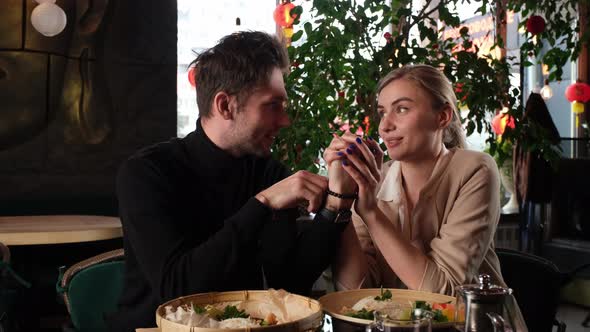 Hand in Hand on a Date in a Restaurant