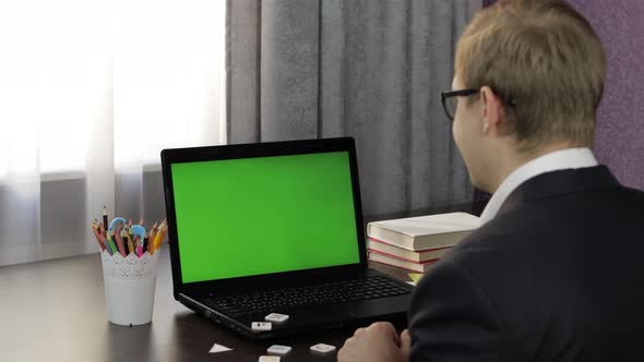 Man Teacher Making Online Video Call on Laptop. Green Screen. Distance Education