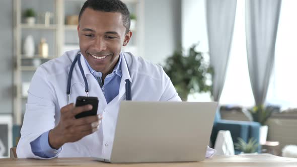 African-American Doctor Using Smartphone for Internet