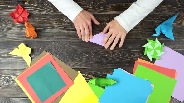 Man Working at Paper Folding Workshop.