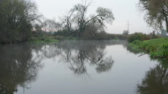 Low flight over the surface of the river with morning fog