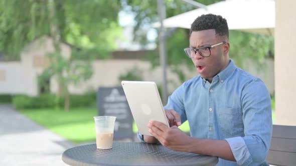 African Man Reacting to Loss on Tablet