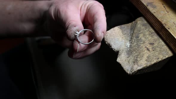 Closeup of Wedding Ring Polishing By Caicasian Jeweler Isolated  Footage