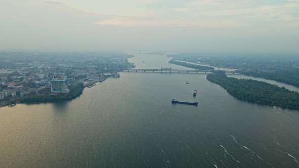 AERIAL Drone Flight Over Big Wide River Dnipro with Cargo Ships Floating to Port