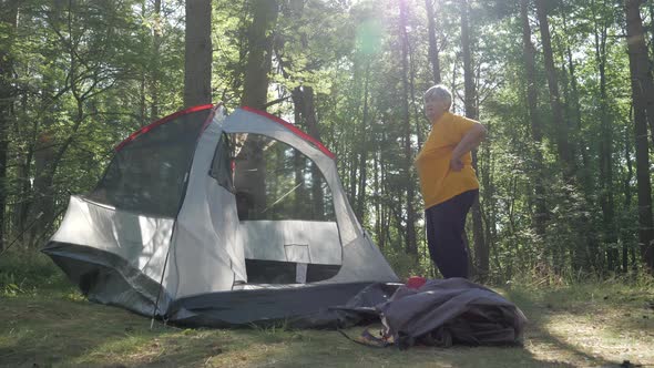 Two Ladies Doing the Tent Assembly in the Campsite