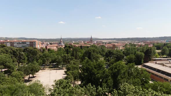 Drone ascend reveal shot of Madrid rooftops and church towers