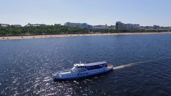 Aerial View Over Wide River and City Skyline Boat is Floating Over Water