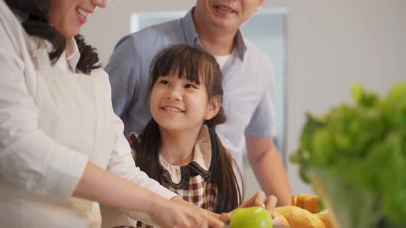 Family relationship, Asian happy family making food preparation in kitchen room at house together.