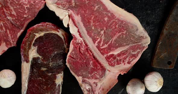 Raw Pieces of Beef on the Table with Garlic. 