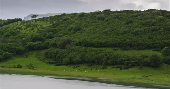 Time Lapse of nature landscape of hills and lake on a cloudy day in Ireland.