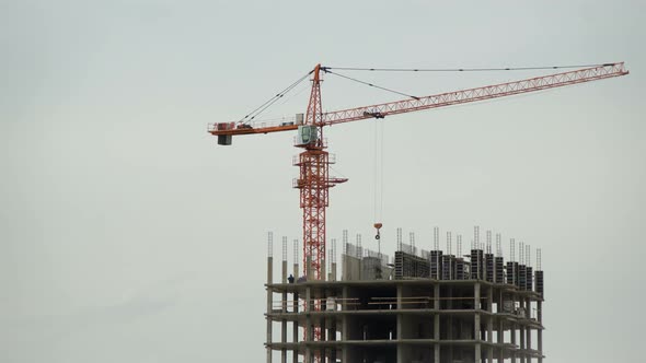 Industry Tower Crane in Action During Construction of New High Rise Buildings