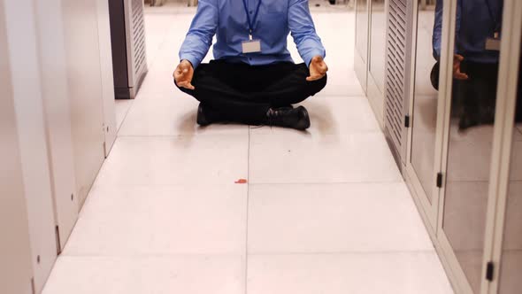 Technician meditating in hallway