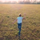 The Child Runs Across the Field Holding a Plane Simulates Flight - VideoHive Item for Sale