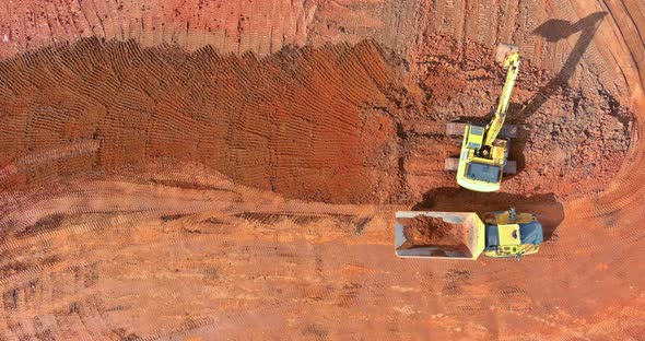 Digger on Earthworks in Excavator Dig the Trenche at Construction Site on Arial View of Earth Moving