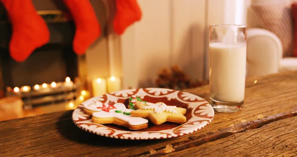 Gingerbread cookies with a glass of milk on wooden table 4k