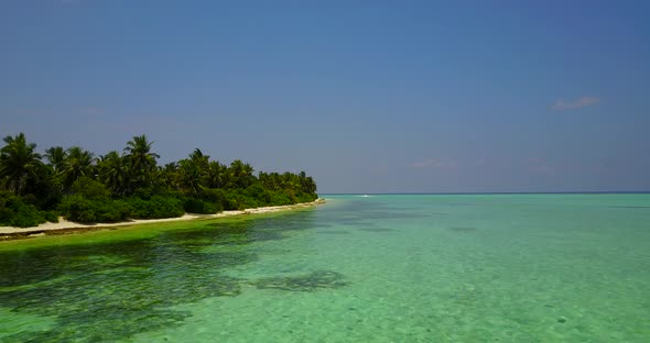 Wide birds eye abstract shot of a white paradise beach and blue ocean background in colourful 4K