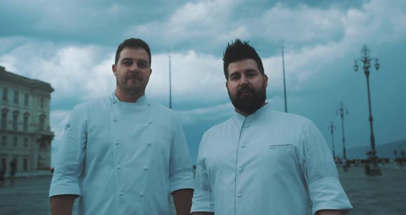 Two chefs look toward camera