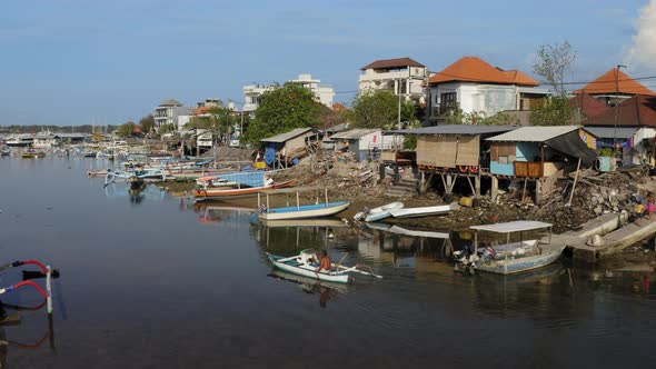 Aerial Drone Flight at Small Fishing Village on the Bay Bali Indonesia