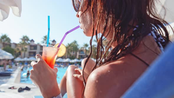 Side View Profile Young Beautiful Woman with Sunglasses is Drinking Cocktail Through Tube and